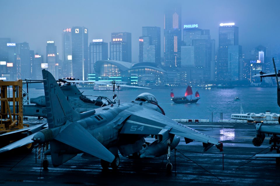 US Marines aircraft carrier with city skyline in the background